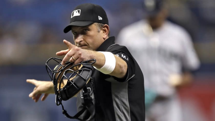 Home plate umpire Chris Guccione pints at Tampa Bay Rays' Kevin Kiermaier during the first inning of