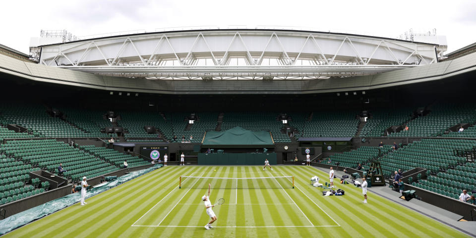 Italy's Jannik Sinner, bottom, and Serbia's Novak Djokovic practice at the All England Lawn Tennis and Croquet Club in Wimbledon, England ahead of the championships which start on Monday, Thursday June 29, 2023. (Steve Paston/PA via AP)