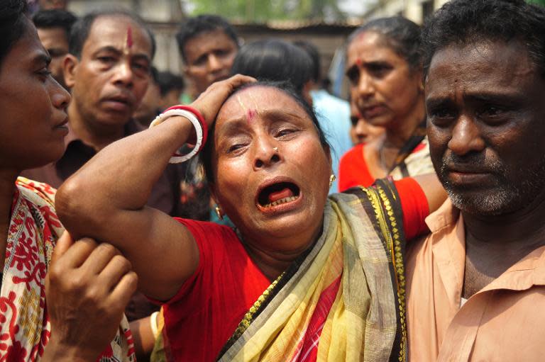 A women grieves after seeing the body of a relative in Narayanganj, south of Dhaka, on March 27, 2015 after their death in a stampede during a Hindu bathing ritual