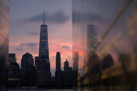 Lower Manhattan is reflected in the Empty Sky memorial on the morning of the 15th anniversary of the 9/11 attacks in New Jersey, U.S., September 11, 2016. REUTERS/Andrew Kelly