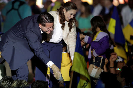 Fabricio Alvarado Munoz, presidential candidate of the National Restoration party (PRN) and his wife Laura Moscoa greets supporters during a rally after the official election results were released in San Jose, Costa Rica April 1, 2018. REUTERS/Juan Carlos Ulate