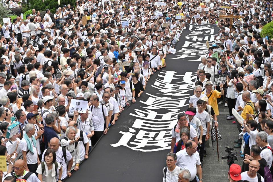 A group of elderly people march to the government headquarters in Hong Kong on July 17, 2019, in the latest protest against a controversial extradition bill. - Hong Kong has been rocked by more than a month of huge largely peaceful protests -- as well as a series of separate violent confrontations with police -- sparked by a law that would have allowed extraditions to mainland China and other countries. (Photo by Anthony WALLACE / AFP)        (Photo credit should read ANTHONY WALLACE/AFP/Getty Images)