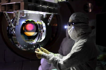 A Laser Interferometer Gravitational-wave Observatory (LIGO) technician performs a Large optic inspection in this undated photo released by Caltech/MIT/LIGO Laboratory on February 8, 2016. REUTERS/Caltech/MIT/LIGO Laboratory/Handout via Reuters