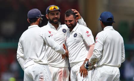 Cricket - India v New Zealand - First Test cricket match - Green Park Stadium, Kanpur, India - 26/09/2016. India's Mohammed Shami celebrates with teammates after taking the wicket of New Zealands's Mark Craig. REUTERS/Danish Siddiqui