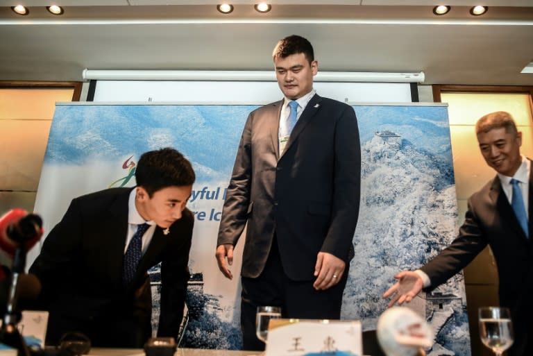 Retired Chinese professional basketball player Yao Ming (C) arrives for a Beijing 2022 Olympics bid committee press briefing in Kuala Lumpur on July 29, 2015