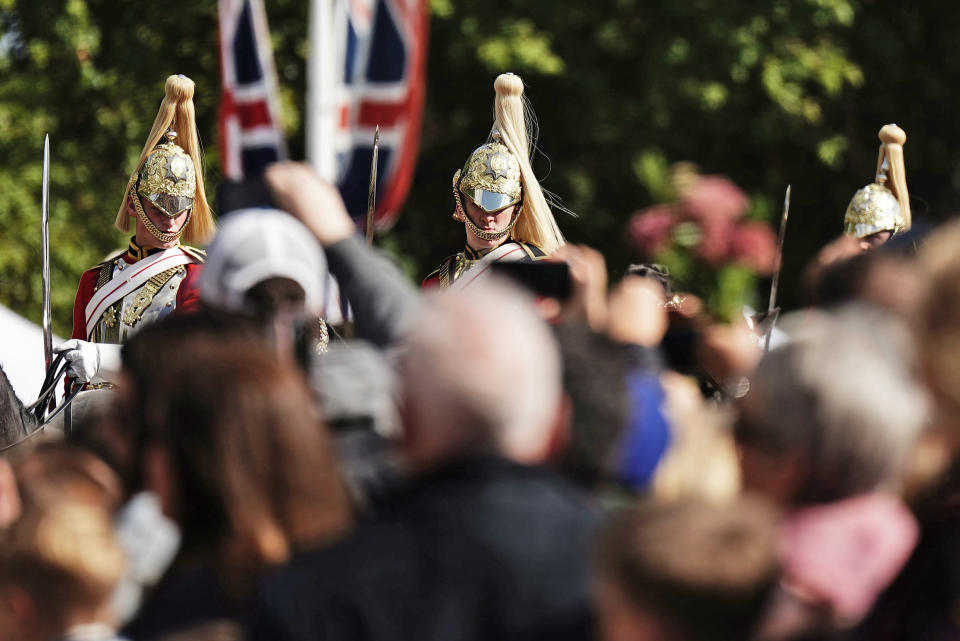 Members of the Household Cavalry ride outside Buckingham Palace, in London, Sunday, Sept. 18, 2022. Hundreds of thousands of people are expected to pack central London for a service attend by 500 emperors, kings, queens, presidents, prime ministers and other leaders from around the world. London's Metropolitan Police says the “hugely complex” policing operation is the biggest in the force’s history, surpassing the London 2012 Olympics. (Aaron Chown/PA via AP)