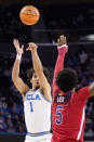 UCLA guard Jules Bernard, left, shoots as Arizona guard Justin Kier defends during the second half of an NCAA college basketball game Tuesday, Jan. 25, 2022, in Los Angeles. (AP Photo/Mark J. Terrill)