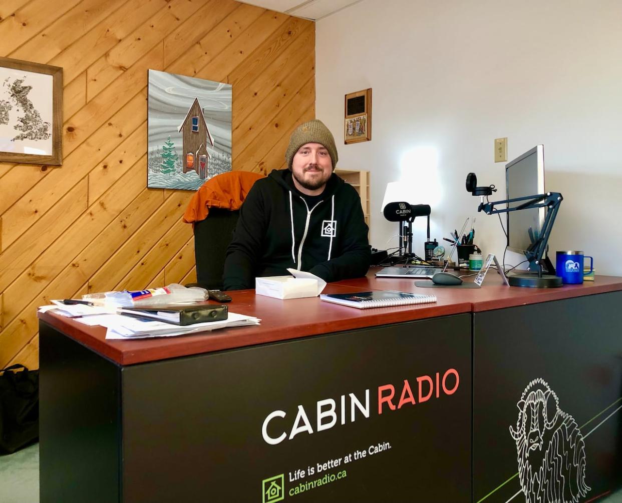 Cabin Radio's editor, Ollie Williams, at Cabin Radio's newsroom in Yellowknife. Cabin Radio has been trying to get an FM license for years.   (Sidney Cohen/CBC - image credit)