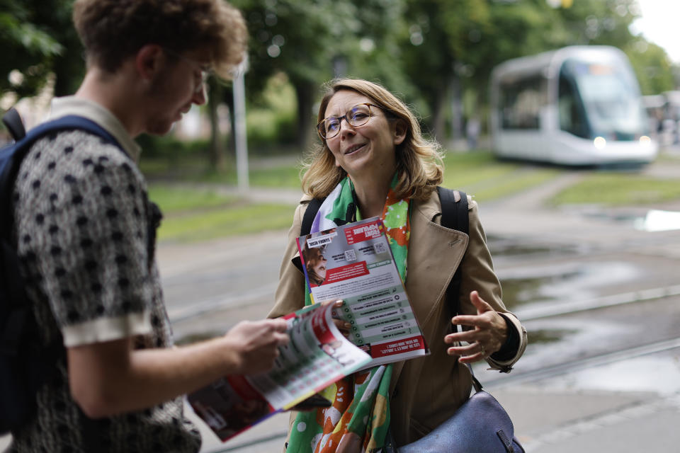 Sandra Regol, a candidate of the leftist coalition Nouveau Front Populaire (New Popular Front) campaigns for the second round of the legislative election, Thursday, July 4, 2024 in Strasbourg, eastern France. French President Emmanuel Macron called the surprise legislative election on June 9 after his centrist alliance suffered a punishing defeat at the hands of the National Rally in French voting for the European Parliament. (AP Photo/Jean-Francois Badias)