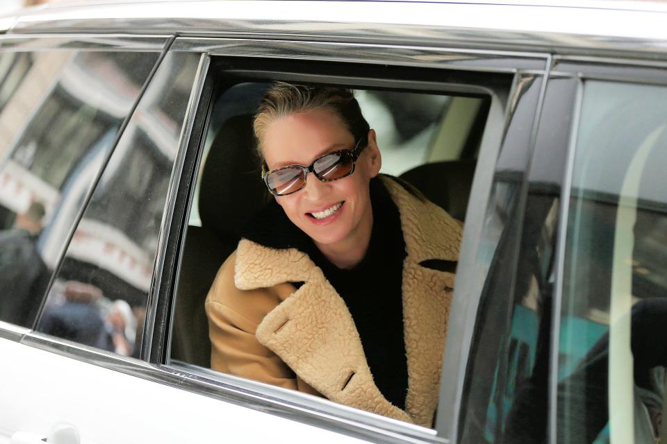 Uma Thurman smiles as her car pulls away from the Build Series office in N.Y.C. on Thursday.