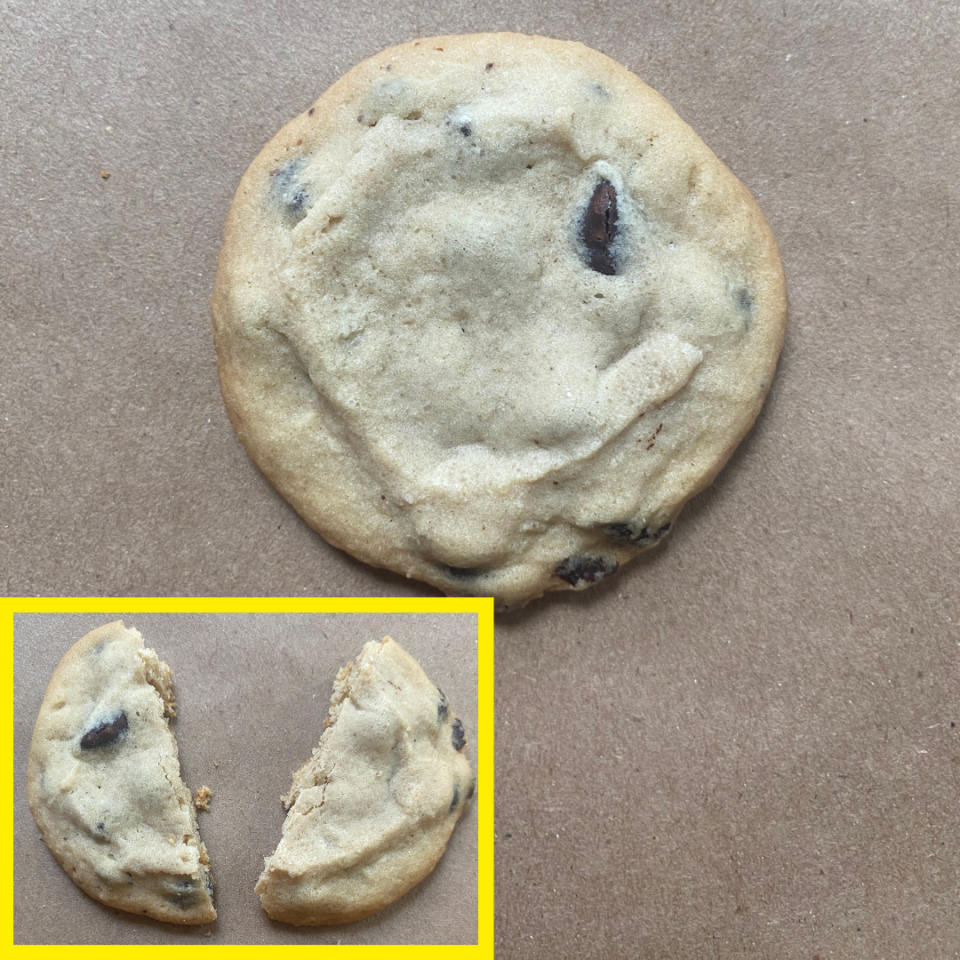 A chocolate chip cookie on a brown surface, with an inset image showing the same cookie broken in half