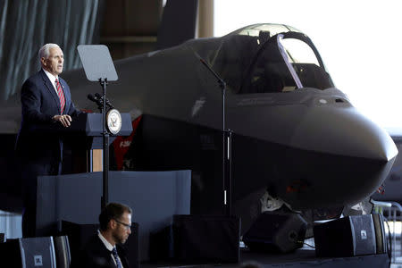 U.S. Vice President Mike Pence addresses members of U.S. military services and Japan Self-Defense Forces (JSDF) in front of a U.S. Air Force F-35 fighter before he departs for South Korea, at U.S. Air Force Yokota base in Fussa, on the outskirts of Tokyo, Japan February 8, 2018. REUTERS/Kiyoshi Ota/Files