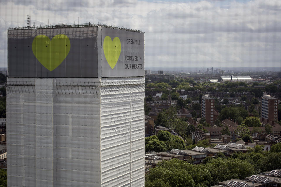 A banner with a green heart is wrapped around the Grenfell Tower one year on since the blaze, which claimed 72 lives. (Photo by Victoria Jones/PA Images via Getty Images)