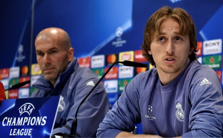 Real Madrid's midfielder Luka Modric speaks next to Real Madrid's coach Zinedine Zidane (L) during a press conference on February 14, 2017, on the eve of the UEFA Champions League football match Real Madrid vs Napoli