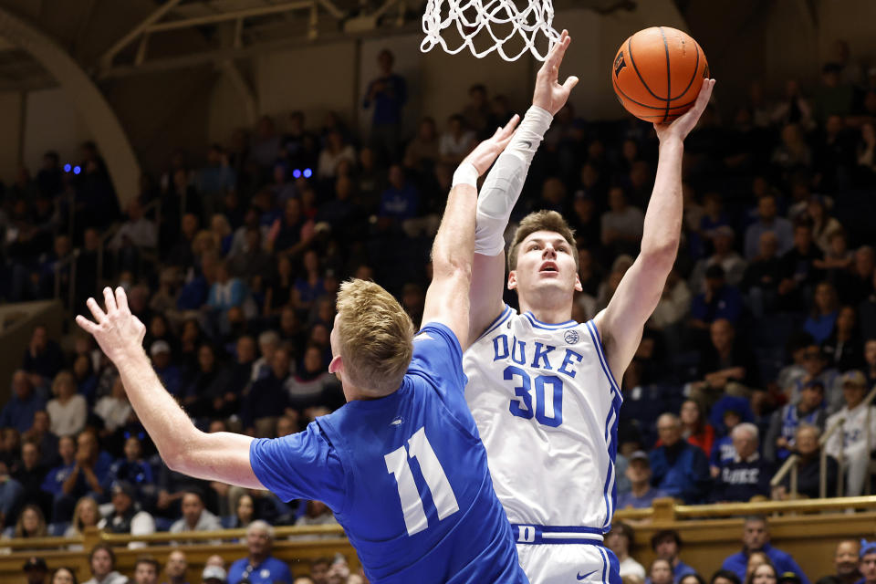 Duke's Kyle Filipowski (30) scores over Hofstra's Jacco Fritz (11) during the first half of an NCAA college basketball game in Durham, N.C., Tuesday, Dec. 12, 2023. (AP Photo/Karl B DeBlaker)