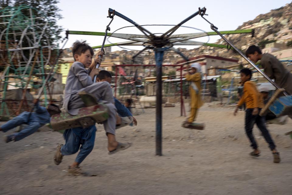 Children have fun in an amusement park near Sakhi Shah-e Mardan Shrine in Kabul, Afghanistan, Monday, June 19, 2023. (AP Photo/Rodrigo Abd)