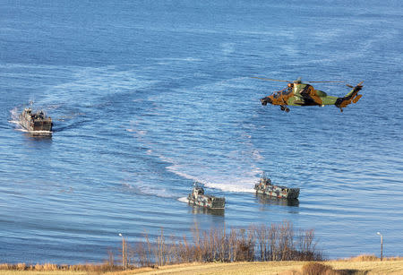 FILE PHOTO: Landing craft and a helicopter are seen during NATO's Exercise Trident Juncture, off the Trondheim coast, Norway October 30, 2018. NTB Scanpix/Gorm Kallestad via REUTERS