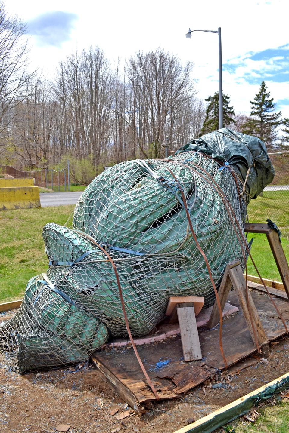 The iconic Taunton Superior Court torch removed in 2003 because of structural concerns, currently rests atop a worn-out piece of Styrofoam near a guard station at the TMLP’s Cleary Flood Generation Station on Somerset Avenue.