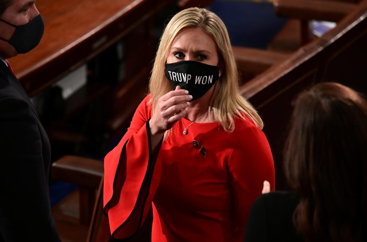 <p>Marjorie Taylor Greene (R-GA) wears a “Trump Won” face mask as she arrives on the floor of the House to take her oath of office as a newly elected member of the 117th House of Representatives in Washington, DC, on 3 January 2021</p> ((Reuters))
