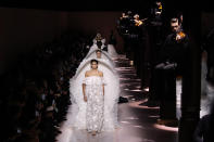 Model Kaia Gerber leads other models as they wear creations for the Givenchy Haute Couture Spring/Summer 2020 fashion collection presented Tuesday Jan. 21, 2020 in Paris. (AP Photo/Christophe Ena)