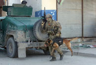 <p>A foreign soldier arrives with his dog on the scene after a suicide bombing in Kabul, Afghanistan, Wednesday, March 1, 2017. A pair of suicide bombings, both claimed by the Taliban, struck the Afghan capitall, an Afghan official said. (AP Photo/Rahmat Gul) </p>