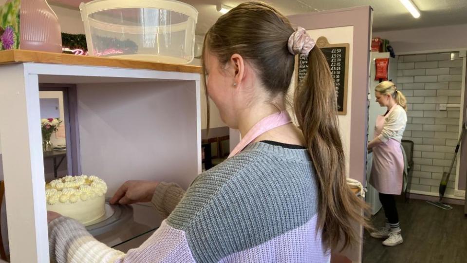 Chloe Frost working in her business with Kimberley White in the background