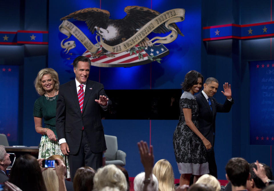 President Barack Obama, right, and first lady Michelle Obama wave as they walk off stage as Republican presidential candidate, former Massachusetts Gov. Mitt Romney, and his wife Ann, say goodbye to the crowd before departing after the third presidential debate on Monday, Oct. 22, 2012, in Boca Raton, Fla. (AP Photo/ Evan Vucci)