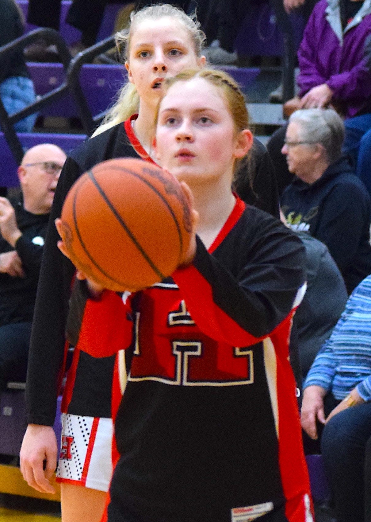 Solomia Tkachuk eyes a shot at warm-ups for Hiland High during a recent basketball game.