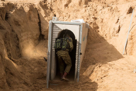 An Israeli soldier enters what the Israeli military say is a cross-border attack tunnel dug from Gaza to Israel, on the Israeli side of the Gaza Strip border near Kissufim January 18, 2018. REUTERS/Jack Guez/Pool