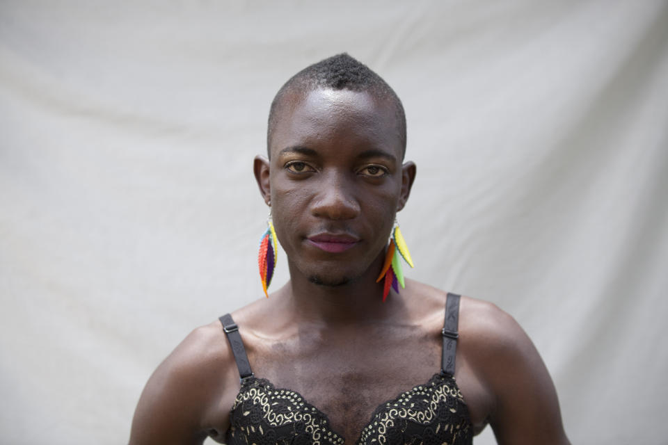 A transgender Ugandan takes part in the 3rd Annual Lesbian, Gay, Bisexual and Transgender (LGBT) Pride celebrations in Entebbe, Uganda, Saturday, Aug. 9,  2014.  Scores of Ugandan homosexuals and their supporters are holding a gay pride parade on a beach in the lakeside town of Entebbe. The parade is their first public event since a Ugandan court invalidated an anti-gay law that was widely condemned by some Western governments and rights watchdogs.(AP Photo/Rebecca Vassie)