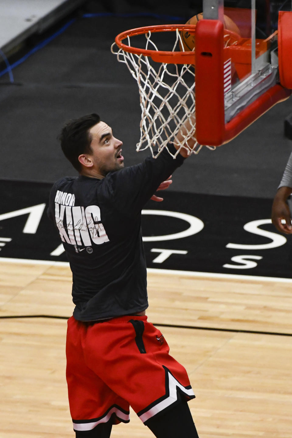 Chicago Bulls guard Tomas Satoransky warms up wearing a shirt that honors Dr. Martin Luther King Jr., before an NBA basketball game against the Houston Rockets, Monday, Jan. 18, 2021, in Chicago. (AP Photo/Matt Marton)