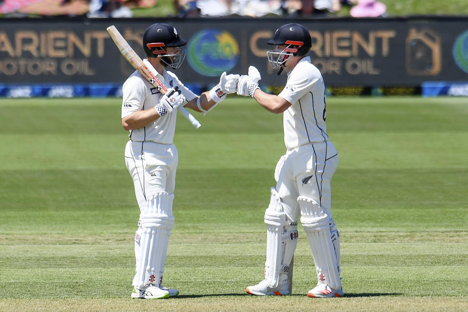 New Zealand's Kane Williamson and Henry Nicholls, right, gesture during play on day two of the second cricket test between Pakistan and New Zealand at Hagley Oval, Christchurch, New Zealand, Monday, Jan 4. 2021. (John Davidson/Photosport via AP)