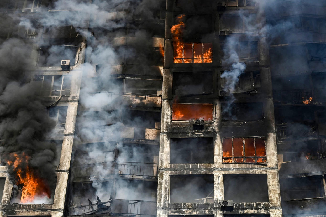 Firefighters work to extinguish a fire in an apartment building in Kyiv on March 15, 2022. (Aris Messinis / AFP - Getty Images)