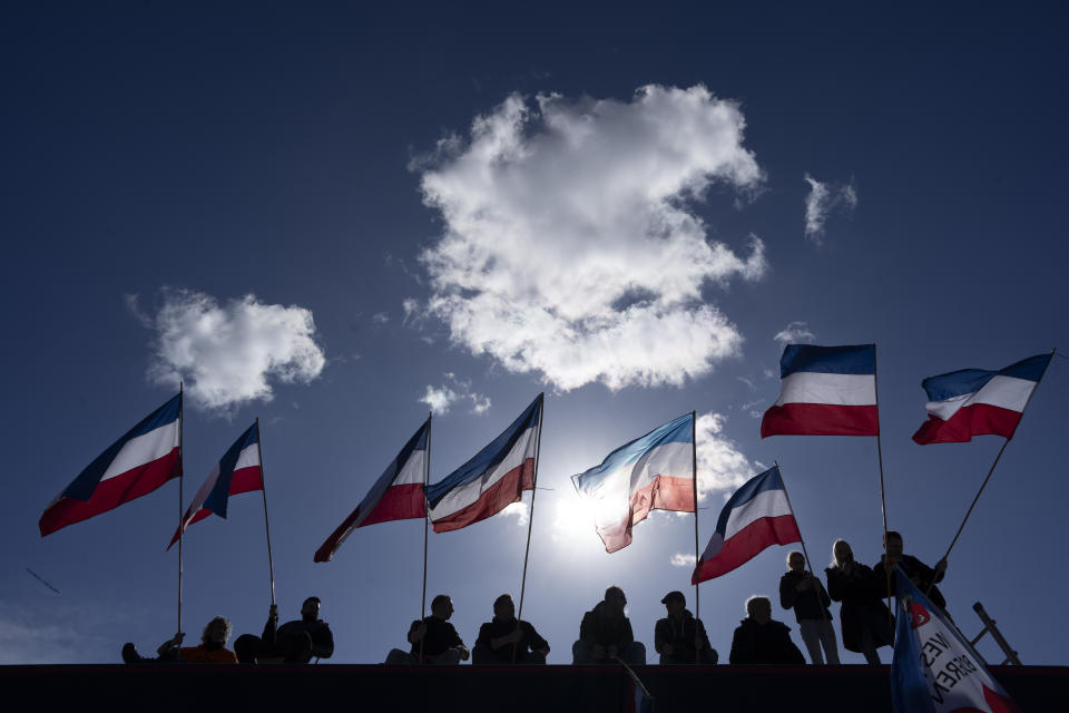 Netherlands flags fly upside-down in protest as thousands of demonstrators joined an anti-government protest by farmers' organizations in The Hague, Netherlands, Saturday, March 11, 2023. The protest comes days before Dutch provincial elections on March 15, in which a party representing farmers' interests is expected to perform well. (AP Photo/Peter Dejong)