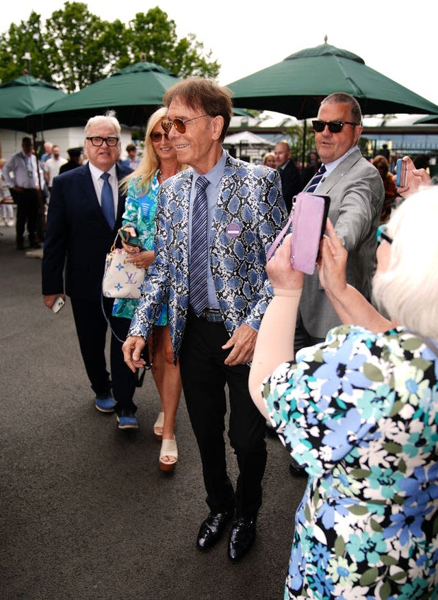 Cliff Richard wearing a lilac snakeskin jacket