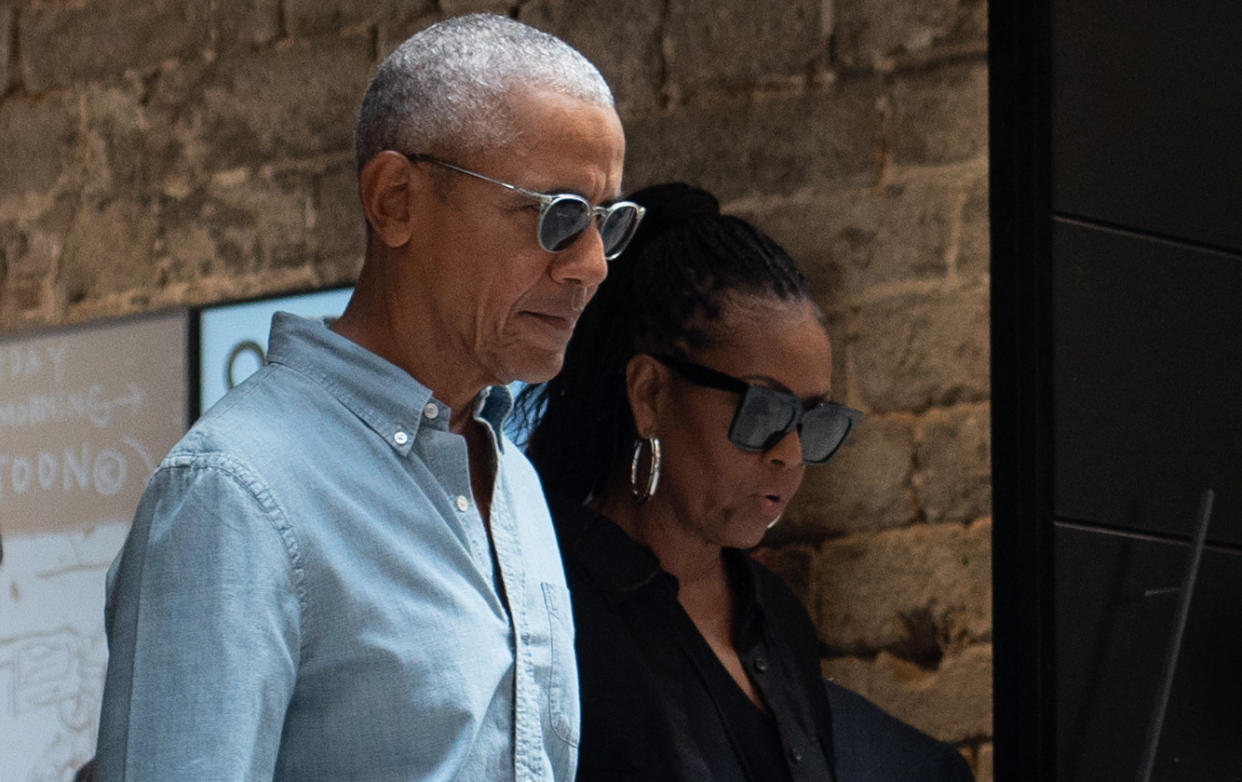 Former President Barack Obama and former first lady Michelle Obama, both wearing sunglasses, during a trip to Spain in April.