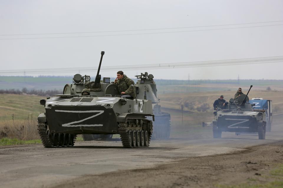 Russian military vehicles move on a highway in an area controlled by Russian-backed separatist forces near Mariupol, Ukraine, Monday, April 18, 2022. Mariupol, a strategic port on the Sea of Azov, has been besieged by Russian troops and forces from self-proclaimed separatist areas in eastern Ukraine for more than six weeks. (AP Photo/Alexei Alexandrov)