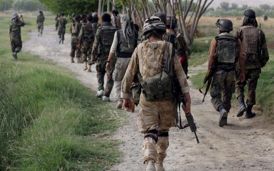 Cpt Alex Corbet Burcher from 1st Battalion Welsh Guards , attached to the Inkerman Company, 1st Battalion Grenadier Guards, patrols with Afghan National Army soldiers on June 1, 2007 in Sangin Valley, Helmand Province, Afghanistan