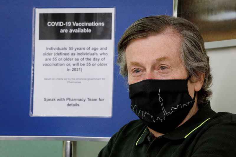 Toronto Mayor John Tory sits in a chair after receiving a dose of the AstraZeneca coronavirus disease (COVID-19) vaccine