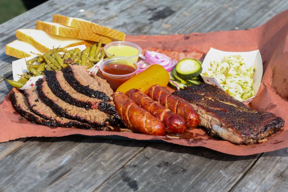 A BBQ spread rests on a table at Full Send Barbecue in downtown Corpus Christi Friday, March 15, 2024.