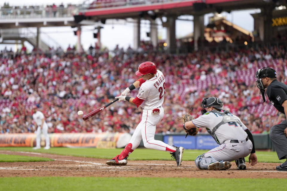 Cincinnati Reds' TJ Friedl (29) hits a two-run triple against the Miami Marlins during the third inning of a baseball game Monday, Aug. 7, 2023, in Cincinnati. (AP Photo/Jeff Dean)