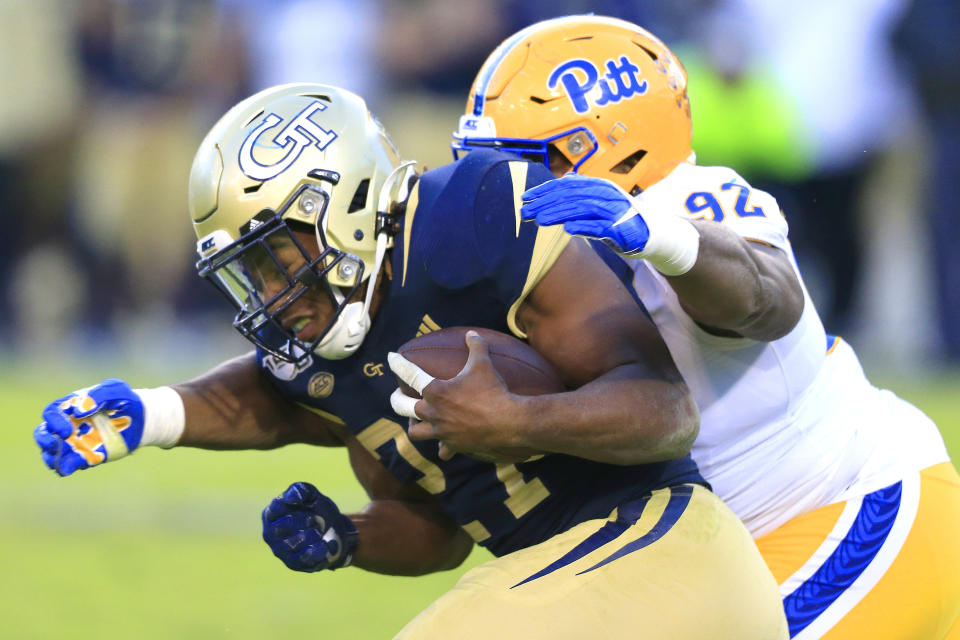 Defensive lineman Tyler Bentley of the Pittsburgh Panthers tackles running back Jordan Mason of the Georgia Tech