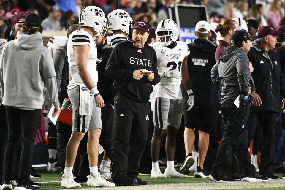 Nov 24, 2022; Oxford, Mississippi, USA; Mississippi State Bulldogs head coach Mike Leach speaks with quarterback Will Rogers (2) during the first quarter of the game against the Ole Miss Rebels at Vaught-Hemingway Stadium. Mandatory Credit: Matt Bush-USA TODAY Sports