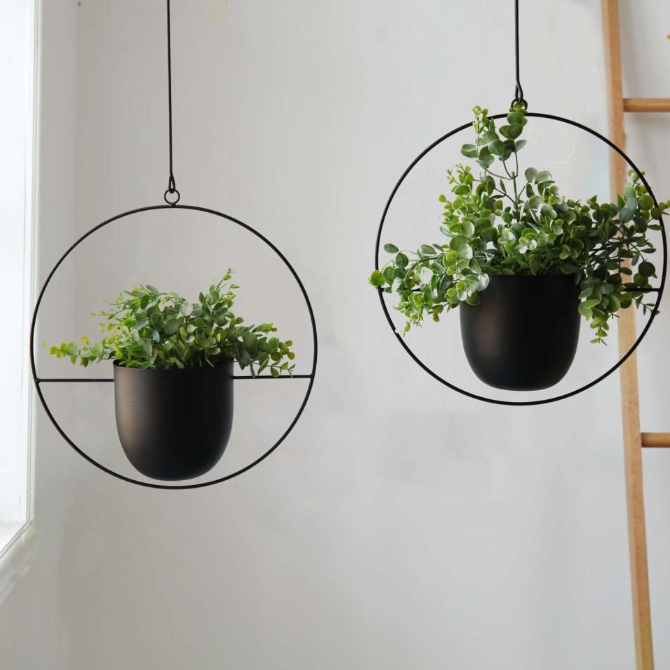 You'll get so many compliments on these you'll love having them a<i>round</i> your place.<br /><br /><strong>Promising review:</strong> "These are the perfect addition to your mid-century modern, boho, farmhouse, or whatever style you're rocking indoor jungle! <strong>I love the versatility of hanging them alone or connecting two or more together!</strong> They fit a standard 6&rdquo; grower pot inside which allows you to remove the plant for easy watering. I highly recommend these!!!!" &mdash; <a href="https://www.amazon.com/gp/customer-reviews/R28CKUGSVBZEN?&amp;linkCode=ll2&amp;tag=huffpost-bfsyndication-20&amp;linkId=6047ebe4537d97368e242841f8e3c280&amp;language=en_US&amp;ref_=as_li_ss_tl" target="_blank" rel="nofollow noopener noreferrer" data-skimlinks-tracking="5854435" data-vars-affiliate="Amazon" data-vars-href="https://www.amazon.com/gp/customer-reviews/R28CKUGSVBZEN?tag=bfmal-20&amp;ascsubtag=5854435%2C12%2C37%2Cmobile_web%2C0%2C0%2C16324230" data-vars-keywords="cleaning,fast fashion" data-vars-link-id="16324230" data-vars-price="" data-vars-product-id="20942027" data-vars-product-img="" data-vars-product-title="" data-vars-retailers="Amazon">Amazon Customer<br /><br /></a><strong>Get them from Amazon for <a href="https://www.amazon.com/Abetree-Hanging-Planters-Ceiling-Minimalist/dp/B07Z34TJ2R?&amp;linkCode=ll1&amp;tag=huffpost-bfsyndication-20&amp;linkId=8f89ee78768b6bd2622e3099be82f5ea&amp;language=en_US&amp;ref_=as_li_ss_tl" target="_blank" rel="nofollow noopener noreferrer" data-skimlinks-tracking="5854435" data-vars-affiliate="Amazon" data-vars-asin="B07Z34TJ2R" data-vars-href="https://www.amazon.com/dp/B07Z34TJ2R?tag=bfmal-20&amp;ascsubtag=5854435%2C12%2C37%2Cmobile_web%2C0%2C0%2C16323378" data-vars-keywords="cleaning,fast fashion" data-vars-link-id="16323378" data-vars-price="" data-vars-product-id="18221612" data-vars-product-img="https://m.media-amazon.com/images/I/51DkuiwnY4L._SL500_.jpg" data-vars-product-title="Abetree 2 Pcs Hanging Planters for Indoor and Outdoor Plants with Hooks and Chains Metal Modern Wall and Ceiling Planter Minimalist Flower Pot Hold Planters Hanger for Home Decor ,Black" data-vars-retailers="Amazon">$20.99+</a> (available as a single or pair).</strong>