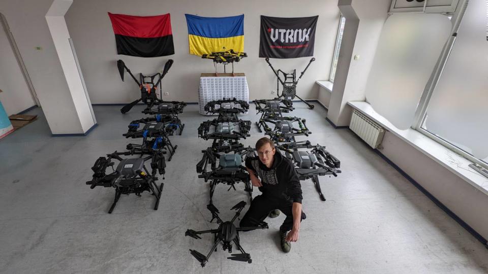 Maxim Sheremet, the founder of Drone Lab, poses with the drones manufactured by his company which are used in battle by the Ukrainian army. (Photo: Maxim Sheremet)