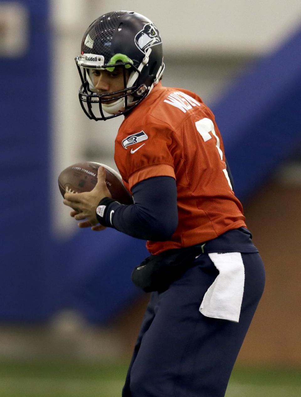 Seattle Seahawks quarterback Russell Wilson handles a ball during NFL football practice Thursday, Jan. 30, 2014, in East Rutherford, N.J. The Seahawks and the Denver Broncos are scheduled to play in the Super Bowl XLVIII football game Sunday, Feb. 2, 2014. (AP Photo)