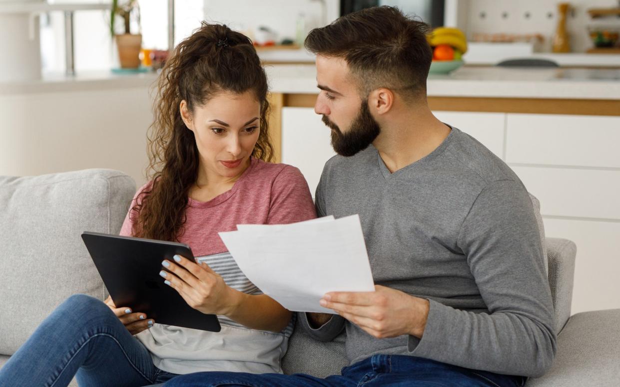 Young couple going over their finances together at home