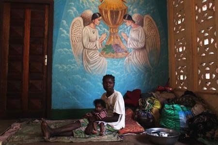 A woman displaced as a result of religious violence rests in a house within the Catholic Church in Bossangao, north of capital Bangui in the Central African Republic December 29, 2013. REUTERS/Andreea Campeanu