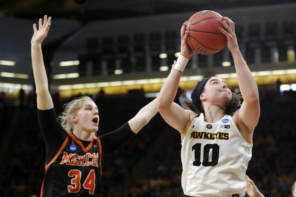 Iowa forward Megan Gustafson drives to the basket past Mercer center Rachel Selph, left, during a first-round game in the NCAA women's college basketball tournament, Friday, March 22, 2019, in Iowa City, Iowa. (AP Photo/Charlie Neibergall)