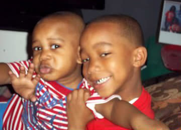 Adrian McDougles, left, with his older brother Onterrio in 2011. (Family photo)